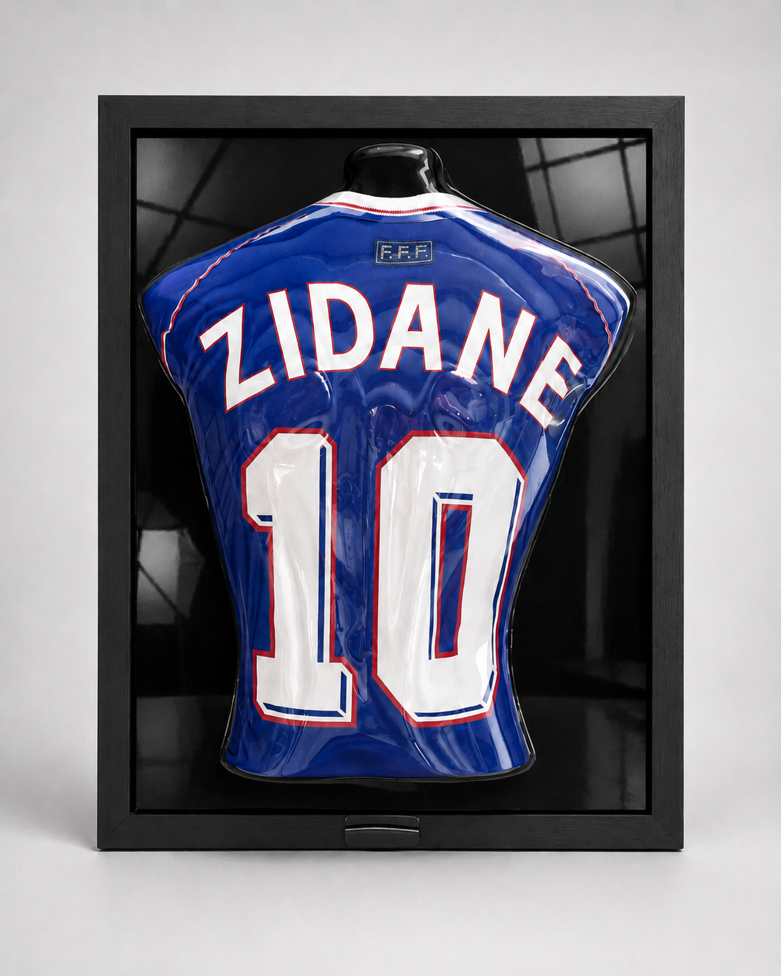 GameFrame - framed, glossy blue soccer jersey displayed on a torso mannequin inside a black 3d display frame. The jersey has 'ZIDANE' and the number '10' in white with red outlines, and a small 'FIFA' patch near the collar.